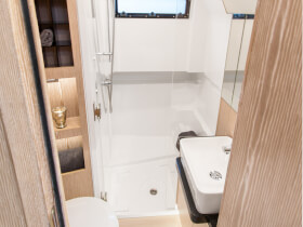 Fjord 44 open | Fully equipped head with separate shower stall with handheld shower and bracket, and comfort seat with wood cover. | Fjord